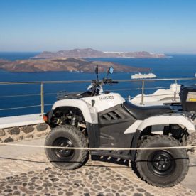 Quadbike (Kymco MXU) overlooking Nea Kameni near Fira on Santorini in The Cyclades, Greece