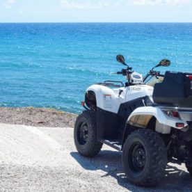 Santorini, Greece, April 2019. Scenic view of the turquoise sea, blue sky, clouds on the island of Santorini, Greece. Rent a vehicle for travel. ATV and scooter. Greek travel.