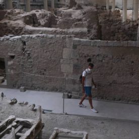 Visitors take a tour in the prehistoric city of Akrotiri which was  inhabited from the Neolithic Age to 1500 BC, when a devastating eruption destroyed everything. Santorini Island, Greece, 17 Aug. 2020